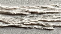 Natural beige cotton rope strands arranged horizontally on textured fabric background for crafting and nautical design projects.