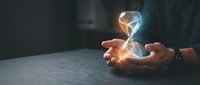 Businessman holding glowing lightbulb with energy waves, representing innovation, creativity, and bright ideas for business solutions and entrepreneurship concepts.