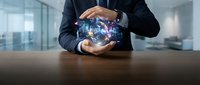 Businessman in dark suit holding glowing digital globe with network connections, representing global business, technology innovation, and international commerce in modern office setting.