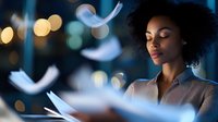 Young African American woman reading with glowing papers floating around her in magical atmosphere with bokeh lights, expressing imagination and creativity.