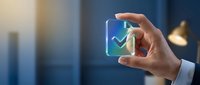Business professional hand holding glowing digital checkmark icon representing success, approval, and quality assurance in modern office environment.