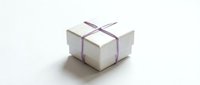 White gift box with purple ribbon bow isolated on clean background for holiday celebrations and special occasions.