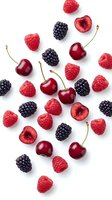 Fresh mixed berries scattered on white background with cherries, raspberries and blackberries isolated for healthy food design and culinary projects.