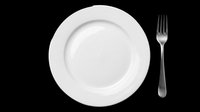 White ceramic dinner plate with fork isolated on transparent background, ready for restaurant menus, food blogs, T-shirt design, clipart, and print on demand projects.