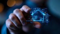 African American male hand interacting with glowing blue holographic house icon floating in dark space, representing smart home technology and digital real estate innovation.