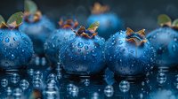 Fresh ripe blueberries with water drops on dark background, macro shot showing juicy berries with natural morning dew reflection for food photography.