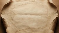 Vintage aged parchment paper with burned edges and weathered texture for antique document designs and historical themed projects.