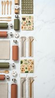 Eco-friendly sustainable lifestyle flat lay with wooden utensils, reusable water bottles, organic cotton textiles, and botanical patterned notebooks on marble background.