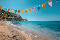 Colorful triangle bunting flags decorating scenic beach view with turquoise ocean waters, sandy coastline and rocky cliffs, perfect for summer vacation advertising and travel inspiration.