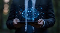 Professional in dark suit holds digital tablet with glowing blue holographic particles floating above, creating magical technology visualization effect in night setting.