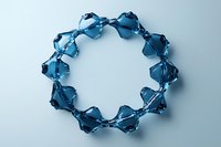 Elegant bracelet made of translucent blue crystal beads arranged in circular pattern on light background, showcasing jewelry design and geometric symmetry.