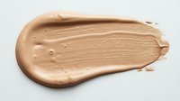 Liquid foundation makeup swatch in warm beige tone isolated on white background, ready for cosmetic design and beauty product advertising use.