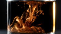 Golden liquid swirls create mesmerizing fluid dynamics in glass container with dramatic backlighting for abstract art and scientific visualization projects.
