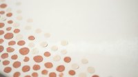 Abstract geometric pattern with copper and beige circles on textured paper background for modern design projects and creative layouts.