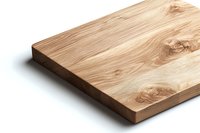 Natural wooden cutting board with distinctive grain pattern and knots on white background, isolated kitchen accessory for food preparation and serving.