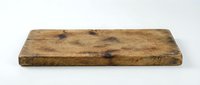 Rustic wooden cutting board with natural grain and weathered finish, isolated on white background for kitchen design, culinary projects, and tableware mockups.