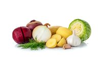 Fresh organic vegetables including red onion, white onion, potatoes, cabbage, garlic and dill herbs isolated on white background for healthy cooking and nutrition.
