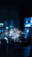 Businessman holding futuristic holographic data visualization with geometric shapes and digital network connections in modern office environment.