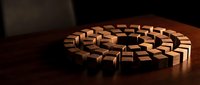 Wooden blocks arranged in circular pattern on dark surface with warm lighting creating geometric design for interior decoration and modern furniture concepts.