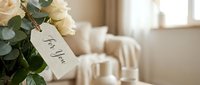 White roses bouquet with thank you gift tag in elegant home interior setting for gratitude expressions and special occasions.