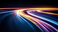 Colorful light trails curve along dark background creating dynamic motion effect with blue, orange and purple streaks, suggesting speed and technology advancement.