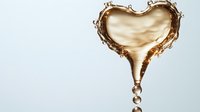 Golden liquid heart shape with droplets falling, romantic love concept for Valentine's Day cards, wedding invitations and anniversary designs on white background.