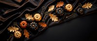 Autumn pumpkins and oak leaves arranged on dark wooden board with vintage keys creating seasonal fall decoration for harvest themed designs.
