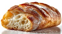 Freshly baked artisan bread loaf with golden crust and airy crumb texture, perfect for bakery menus, food blogs, and culinary marketing materials.