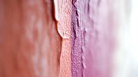 Soft gradient abstract background with textured surface in pink and purple tones showing gentle transition and organic pattern. Macro photography reveals delicate details.