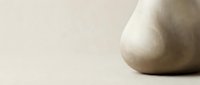 Minimalist ceramic vase with organic curved form on neutral beige background for modern interior design and home decor styling projects.