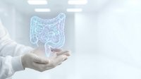 Medical professional in white coat presenting holographic digestive system model for healthcare education and gastroenterology consultation.