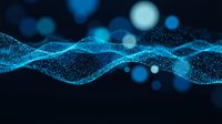 Abstract blue digital wave made of glowing particles flowing across dark background with bokeh lights for technology and data visualization concepts.