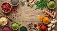 Colorful superfood ingredients arranged on rustic wooden background with copy space. Healthy organic spices, herbs, seeds and powders for nutrition.