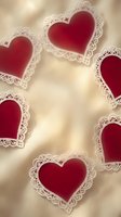 Red hearts with white lace borders on warm beige background for Valentine's Day cards, wedding invitations, romantic decorations and love-themed designs.