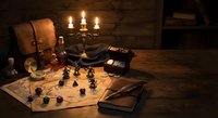 Medieval fantasy tabletop gaming setup with dice, miniatures, maps and candlelight creating atmospheric dungeon master workspace for role-playing adventures.