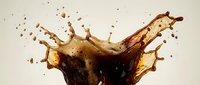 Dynamic cola splash with droplets and bubbles creating crown-like formation on neutral background. Refreshing beverage motion capture for advertising and marketing.