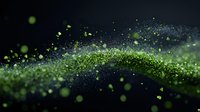 Glowing green particles flow in dynamic wave pattern against dark background, creating magical ethereal effect with bokeh lights and sparkles.