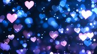 Glowing pink and blue hearts floating on dark background with bokeh effect and light particles create romantic atmosphere for Valentine's Day designs.
