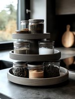 Tiered wooden spice rack with glass jars containing various seasonings and ingredients, organized for kitchen storage and easy access to cooking essentials.