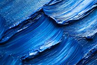 Blue oil paint brush strokes with thick impasto texture creating abstract artistic background for creative projects and modern design applications.