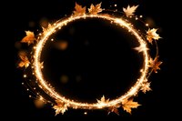 Glowing golden circle frame with autumn maple leaves and sparkles on black background, magical seasonal border for fall designs and decorations.
