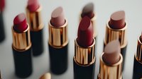 Luxury lipstick collection in golden tubes with various shades from nude to deep red arranged on white surface for beauty and cosmetics branding.