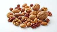 Mixed nuts collection with walnuts almonds pecans hazelnuts cashews on white background isolated for healthy snacking and cooking ingredients.