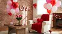 Romantic Valentine's Day living room interior with red and pink balloons, cozy armchair, roses, and love decoration for holiday celebration.