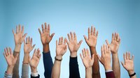 Diverse group of hands raised up in air showing unity and participation against blue gradient background for teamwork and volunteer concepts.