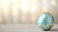 Decorative turquoise Easter egg with golden geometric pattern on wooden surface against soft blurred background. Elegant holiday composition with copy space.