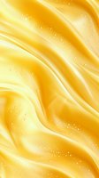 Luxurious golden silk fabric with soft waves and sparkles creates elegant abstract background for luxury product presentations and festive designs.