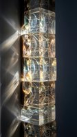 Stacked transparent acrylic blocks with embedded circuit patterns and golden lighting effects creating futuristic technology display for modern design projects.