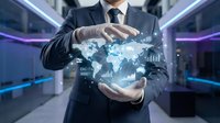 Professional businessman in dark suit holding holographic world map with digital data analytics and global network connections in modern technology corridor.