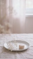 Minimalist composition featuring white macarons and dried baby's breath on marble surface with soft natural light, ideal for bakery, confectionery, and lifestyle design projects.